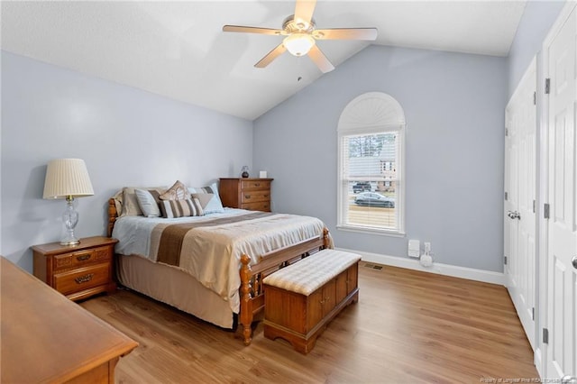 bedroom with vaulted ceiling, ceiling fan, and light hardwood / wood-style flooring