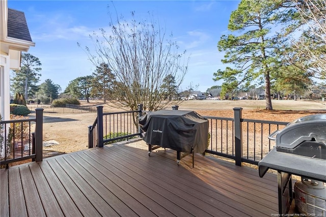 wooden terrace with a grill