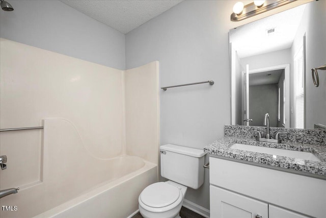 full bathroom featuring shower / tub combination, vanity, toilet, and a textured ceiling