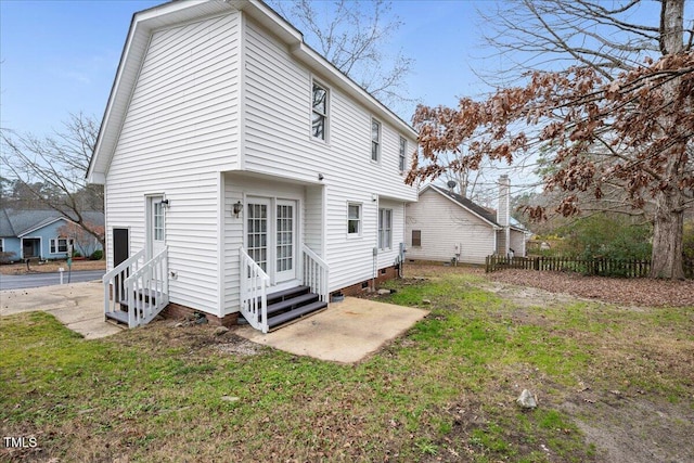 rear view of property featuring a yard