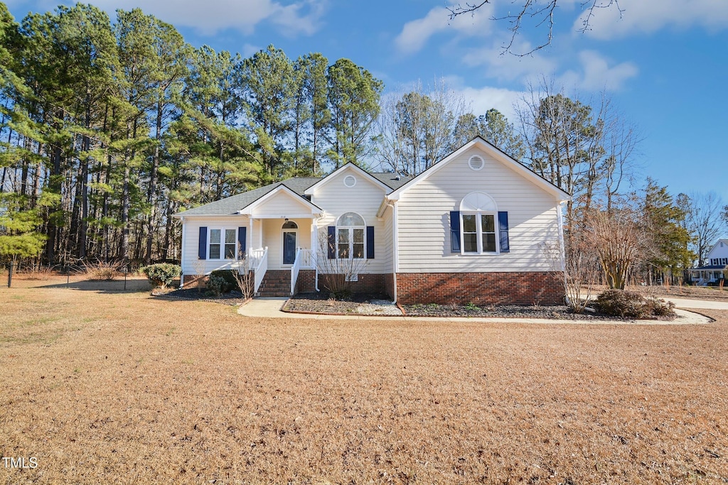 ranch-style home featuring a front yard and a porch