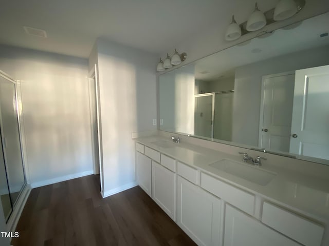 bathroom featuring vanity, hardwood / wood-style flooring, and an enclosed shower