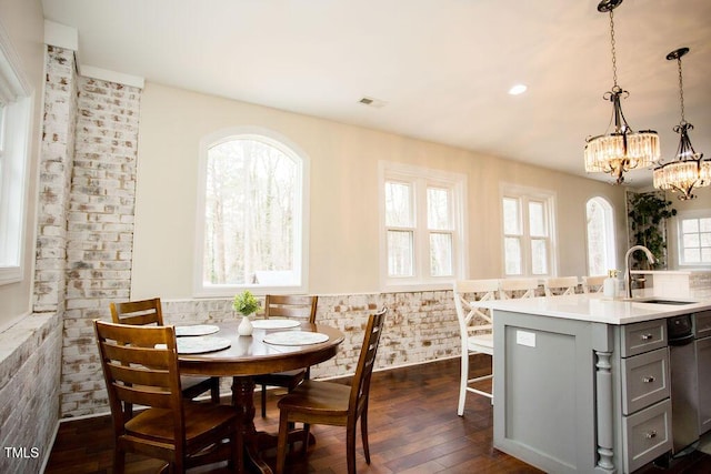 dining space with dark hardwood / wood-style flooring and sink