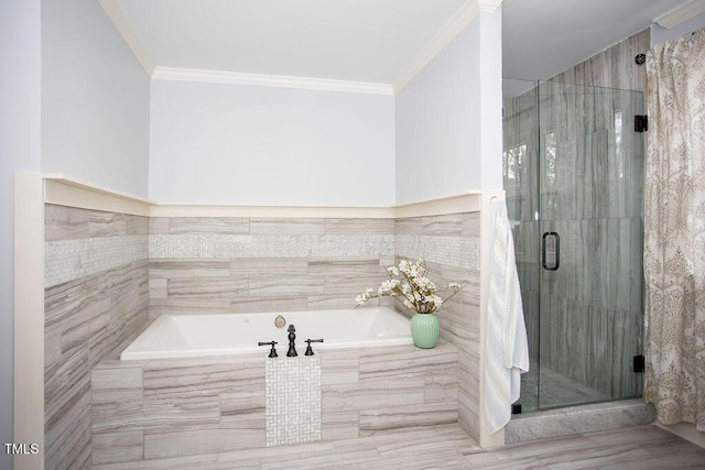 bathroom featuring ornamental molding and separate shower and tub