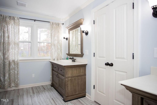 bathroom featuring crown molding and vanity