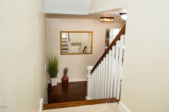 staircase featuring parquet flooring