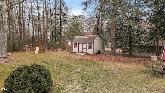 view of yard featuring a playground and a storage unit