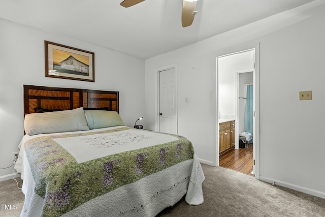 bedroom with light colored carpet, ceiling fan, and ensuite bathroom