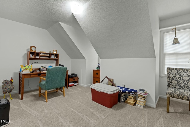 carpeted office space featuring vaulted ceiling and a textured ceiling