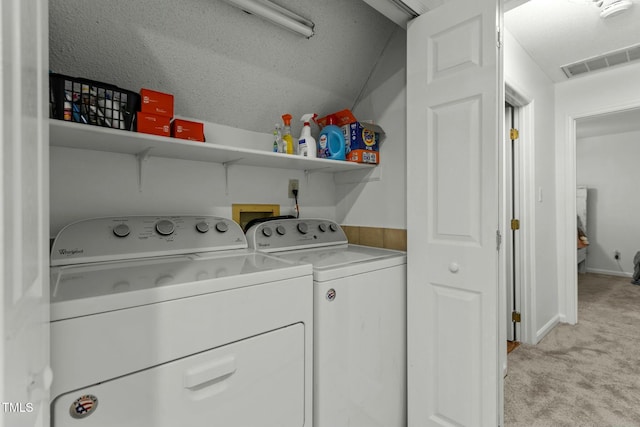 laundry area featuring separate washer and dryer and light carpet