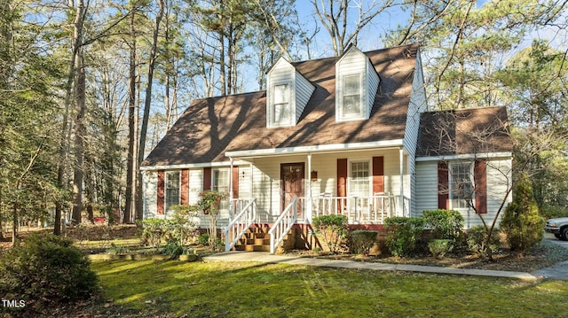 cape cod-style house featuring a porch and a front lawn