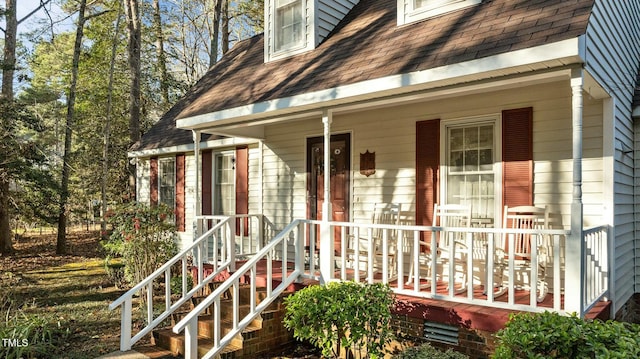 view of exterior entry with covered porch