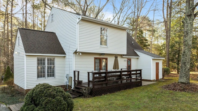 rear view of property featuring a wooden deck and a yard