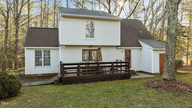 back of property with a wooden deck and a lawn