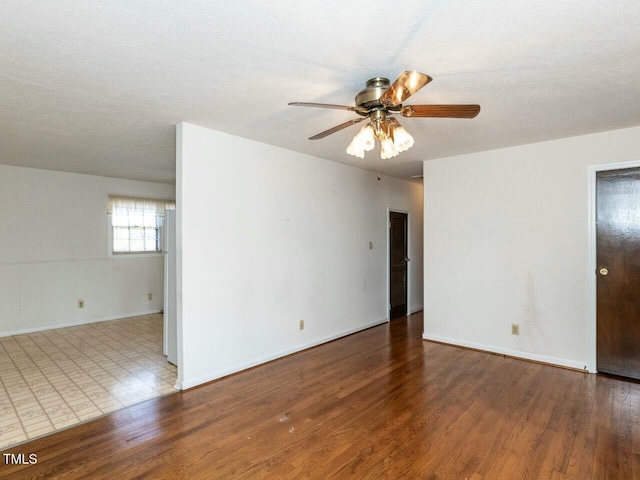 empty room featuring hardwood / wood-style floors, a textured ceiling, and ceiling fan