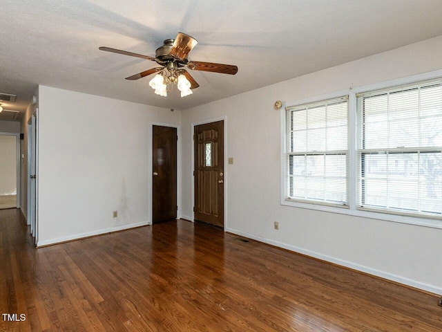 spare room with dark hardwood / wood-style floors and ceiling fan