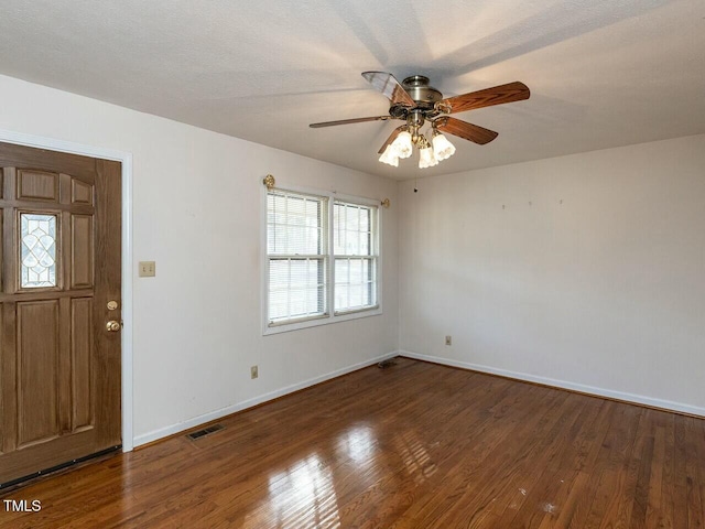 foyer entrance featuring dark hardwood / wood-style floors, a textured ceiling, and ceiling fan