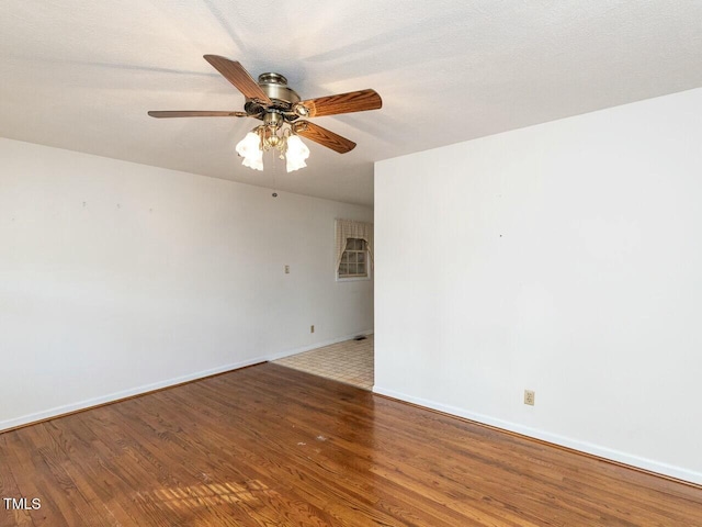 empty room with hardwood / wood-style floors, a textured ceiling, and ceiling fan