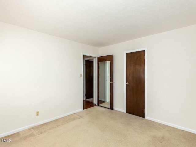 unfurnished bedroom with light colored carpet