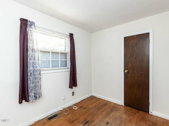 empty room with wood-type flooring