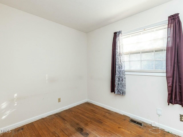 unfurnished room with hardwood / wood-style floors