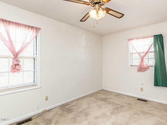 carpeted empty room featuring ceiling fan