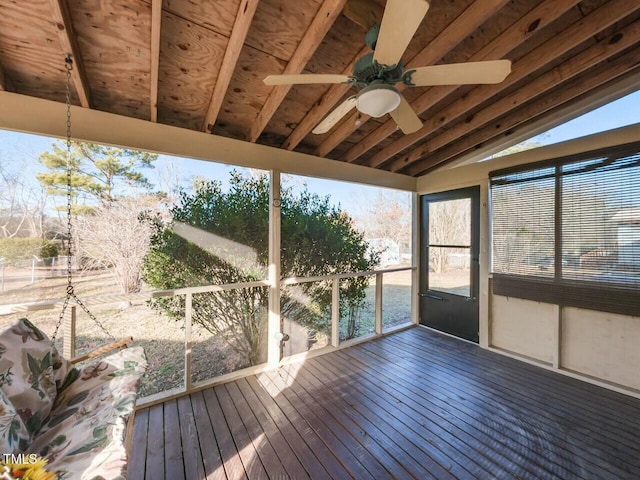 unfurnished sunroom with vaulted ceiling and ceiling fan