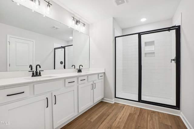 bathroom featuring vanity, hardwood / wood-style flooring, and walk in shower