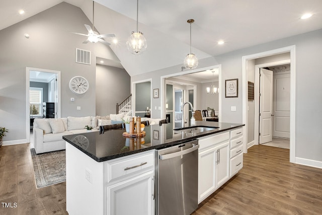 kitchen with sink, wood-type flooring, white cabinets, a center island with sink, and stainless steel dishwasher