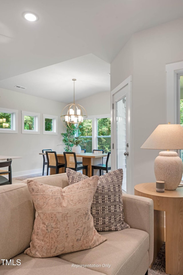 living room with recessed lighting, a wealth of natural light, and a notable chandelier