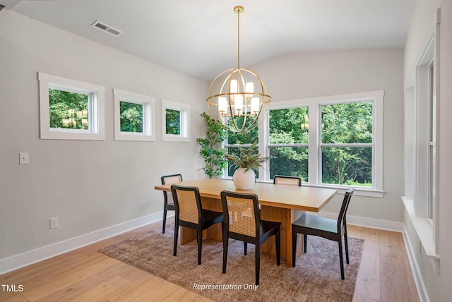 dining space featuring light wood-type flooring, visible vents, baseboards, and a chandelier