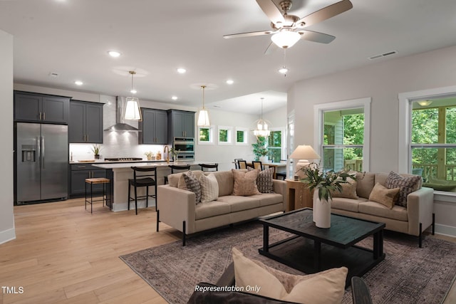 living room featuring light hardwood / wood-style floors and ceiling fan