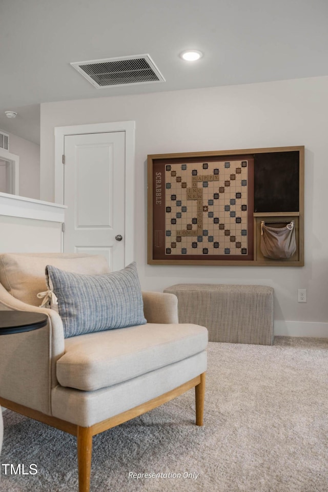 sitting room with carpet, recessed lighting, visible vents, radiator heating unit, and baseboards