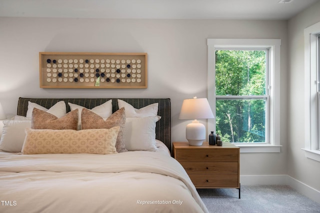 carpeted bedroom with baseboards