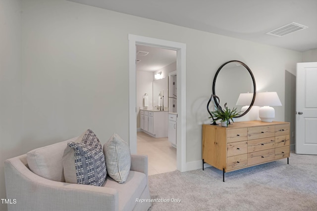 living area with light carpet, baseboards, and visible vents