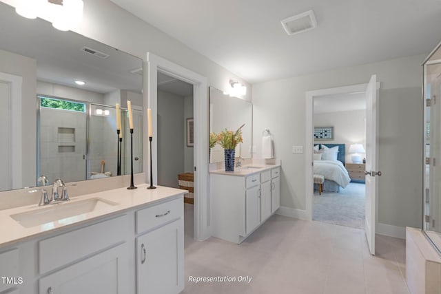 full bathroom featuring visible vents, two vanities, a stall shower, connected bathroom, and a sink