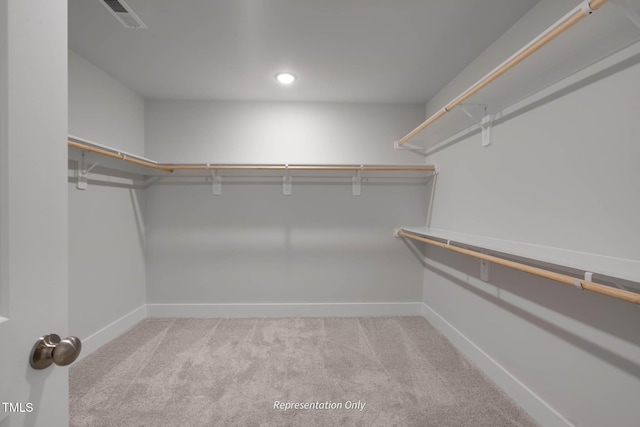 walk in closet with light carpet and visible vents