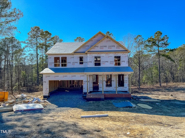 property under construction with covered porch, driveway, and a garage