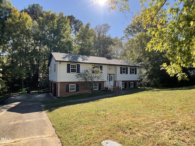 bi-level home with a garage and a front yard