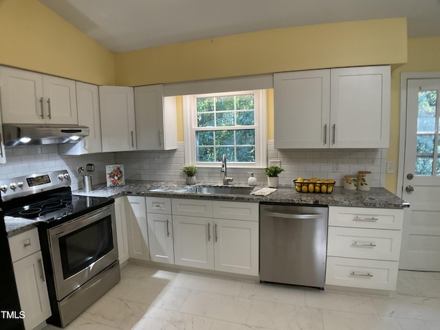 kitchen featuring appliances with stainless steel finishes, white cabinetry, tasteful backsplash, and sink