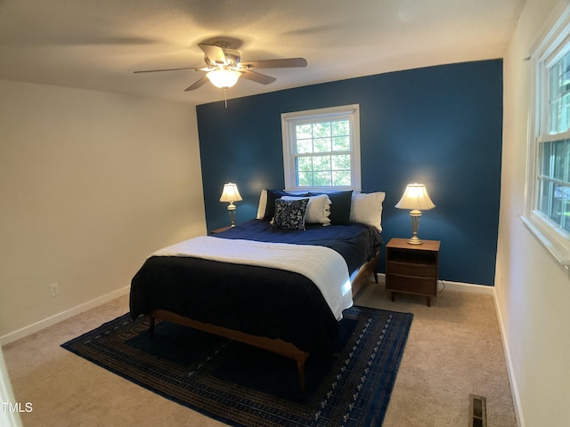 bedroom featuring ceiling fan and carpet