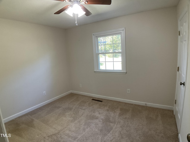 carpeted empty room featuring ceiling fan