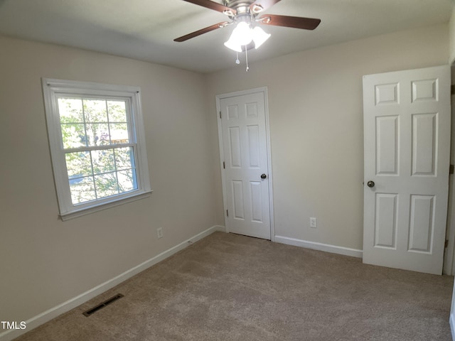 unfurnished bedroom with ceiling fan and light colored carpet