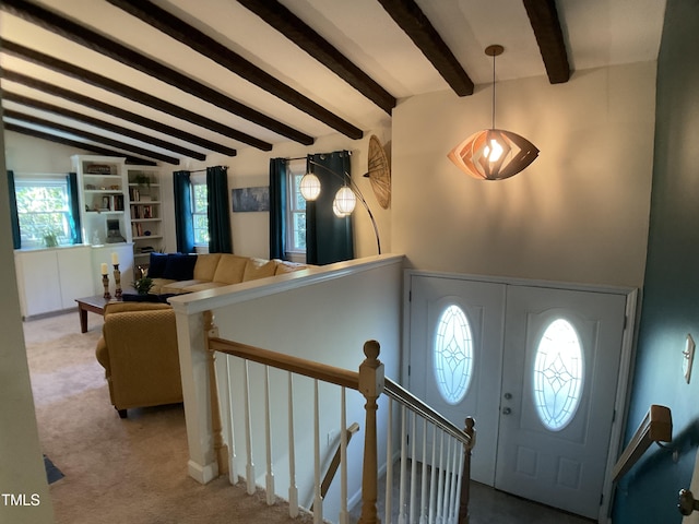 entrance foyer featuring carpet and lofted ceiling with beams