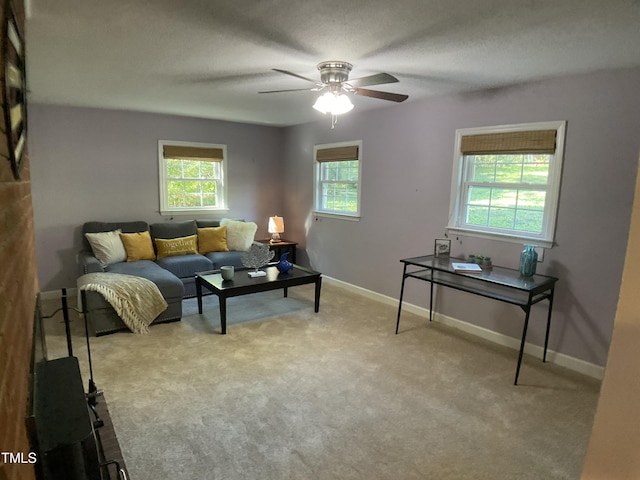 carpeted living room with ceiling fan, a textured ceiling, and a healthy amount of sunlight