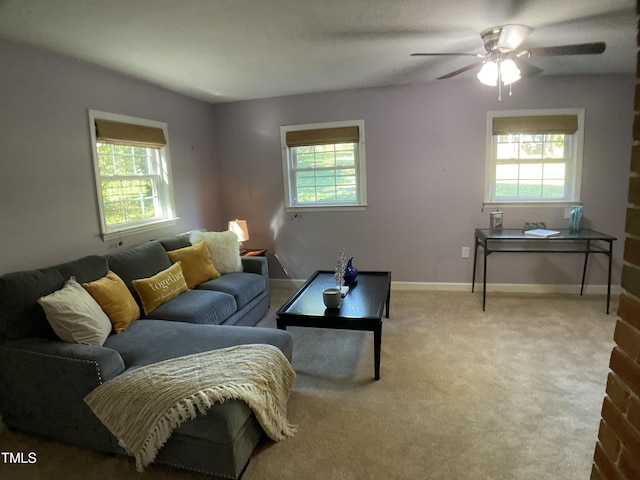 carpeted living room featuring ceiling fan