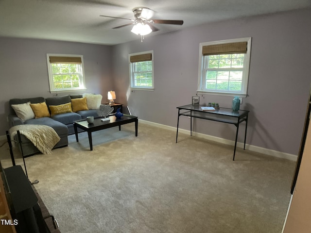 carpeted living room featuring ceiling fan