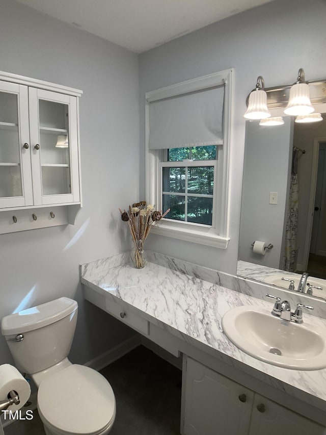 bathroom featuring toilet and vanity