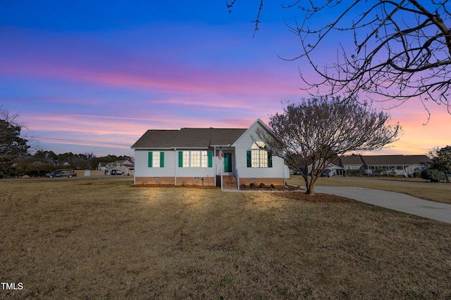 ranch-style home featuring a lawn