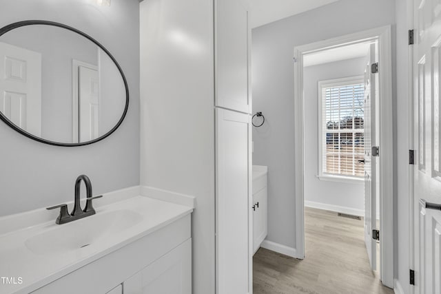 bathroom featuring vanity and hardwood / wood-style flooring